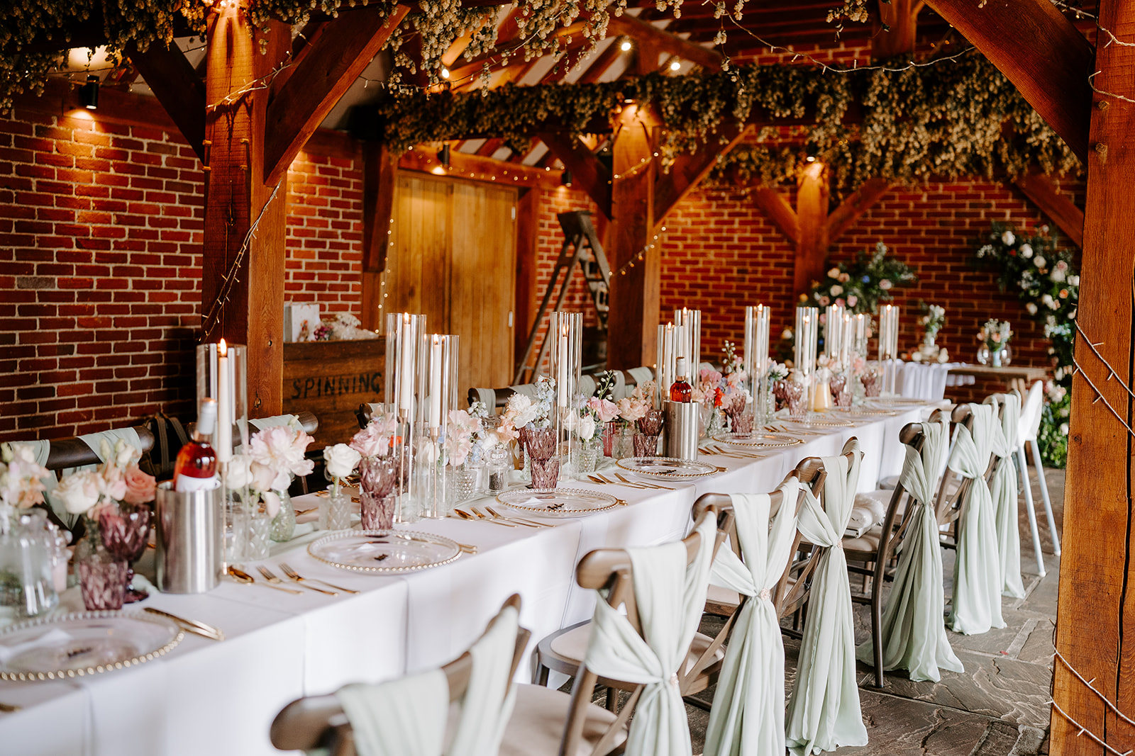 Banquet-style table set for an intimate wedding breakfast at a barn venue