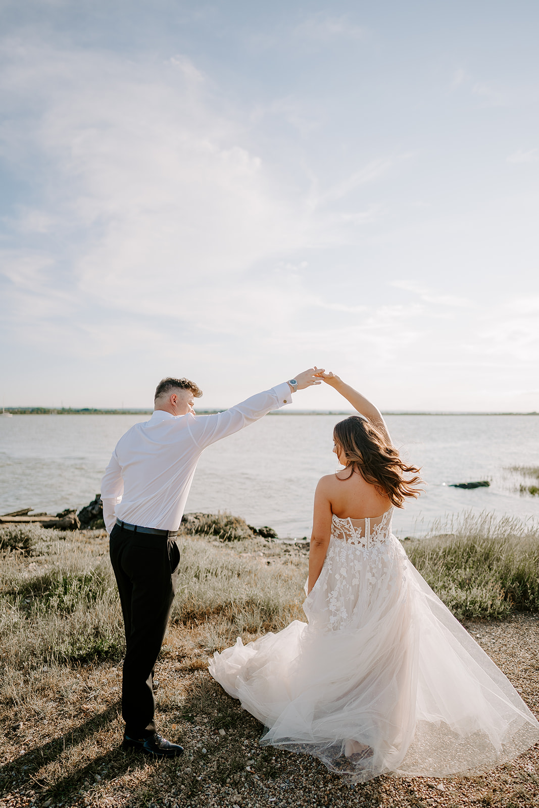 Bride and groom dance beside the water at country wedding venue in Kent