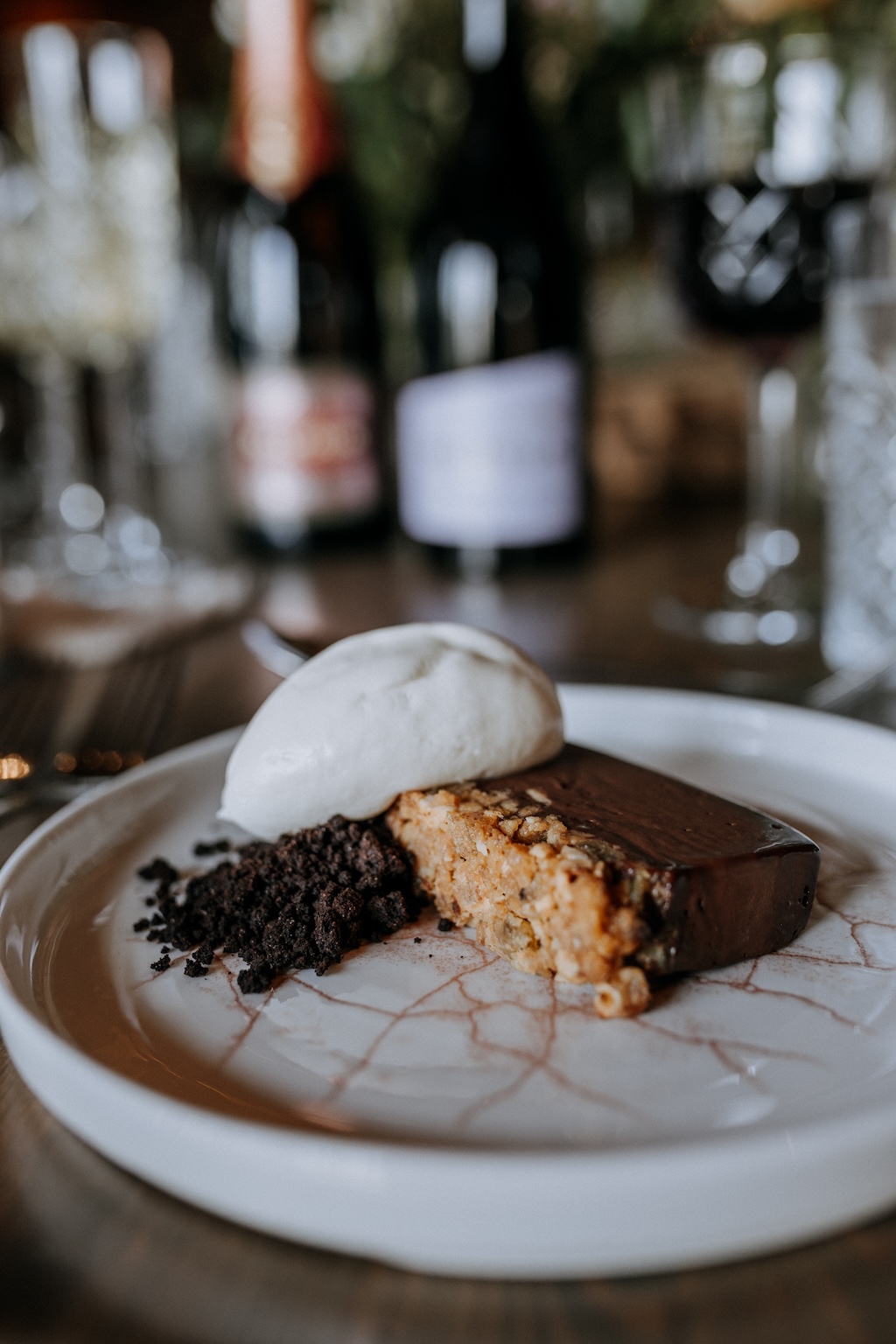 Gourmet chocolate wedding dessert served at rustic barn table with Kent wine