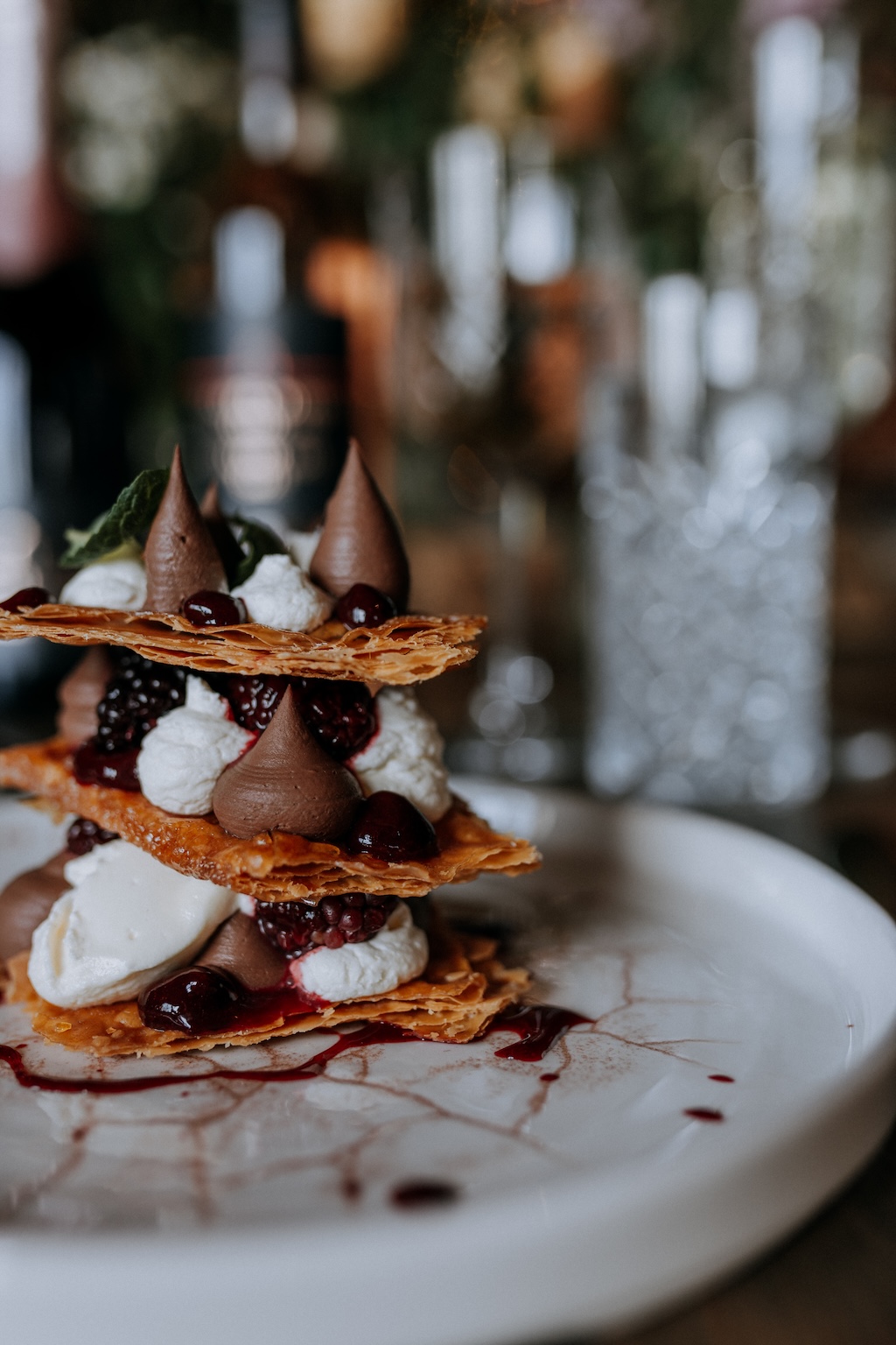 Impressive stacked wedding dessert with berries, cream and chocolate mousse