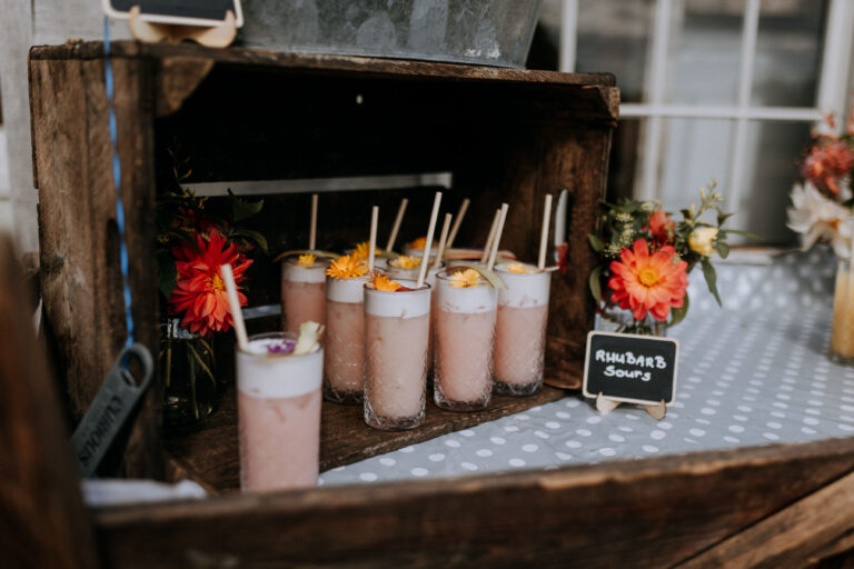 Rhubarb sour cocktails served in a rustic apple crate at a barn wedding venue in Kent