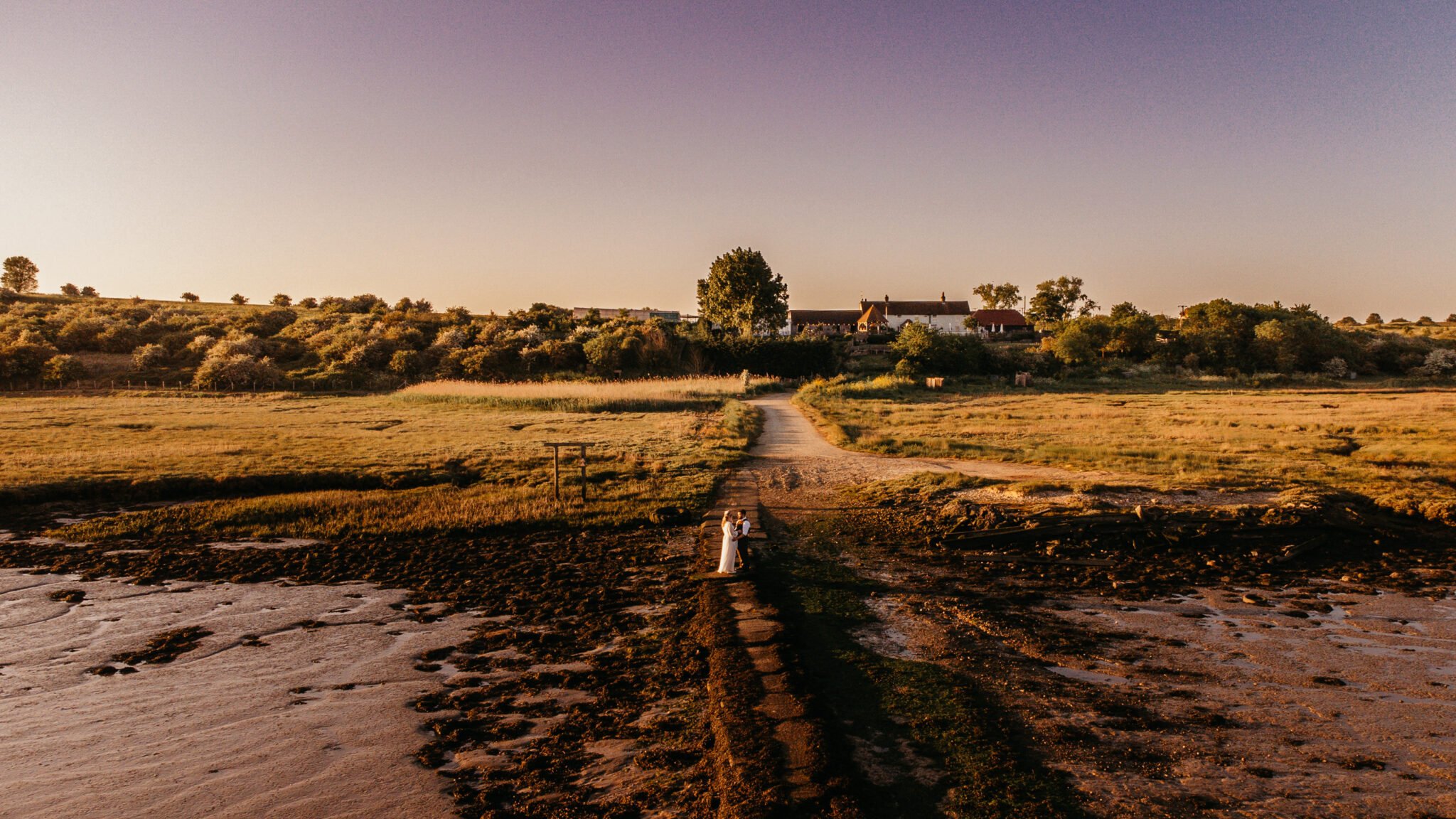 Wedding couple beside the estuary at the Harty Estate wedding and events venue in Kent