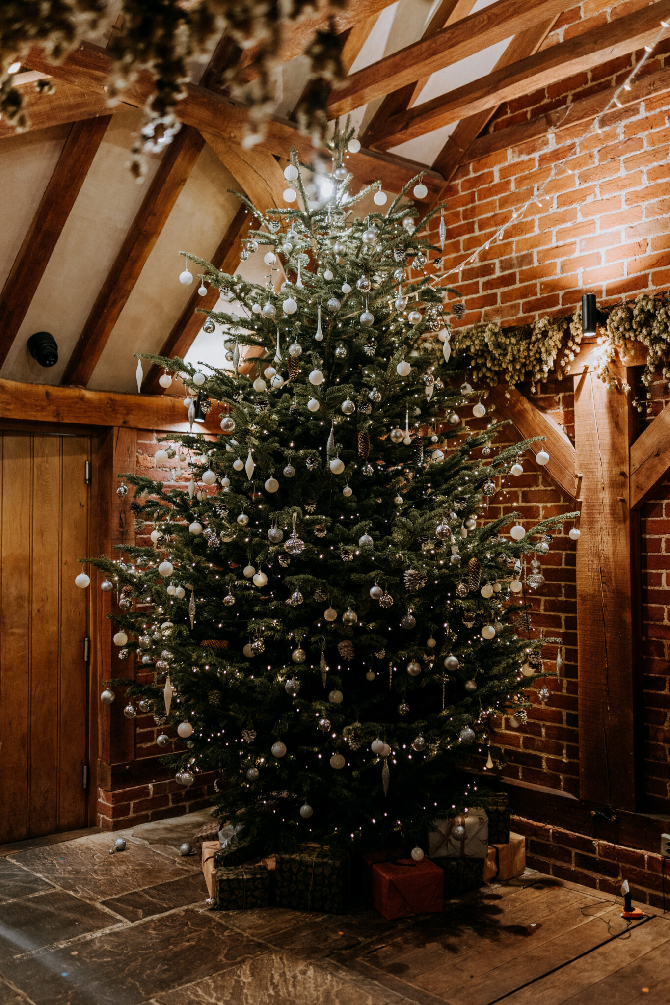 Enormous Christmas tree in a rustic wedding barn