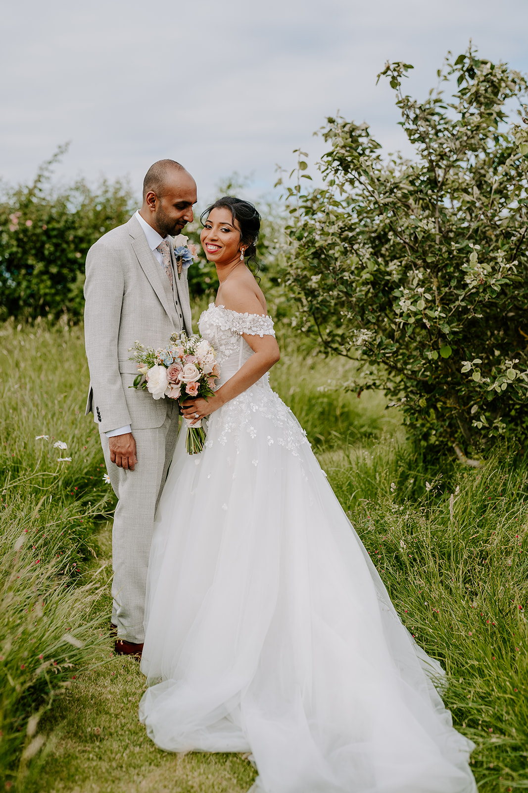 Newlyweds in The Harty Estate orchard in Kent
