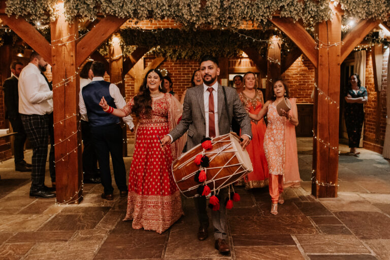 An indian bride celebrating her cultural wedding with traditional music and drums